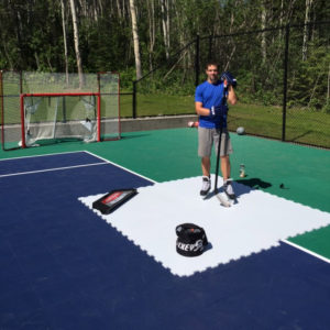 A player uses Hockeyshot synthetic ice tiles for shooting practice